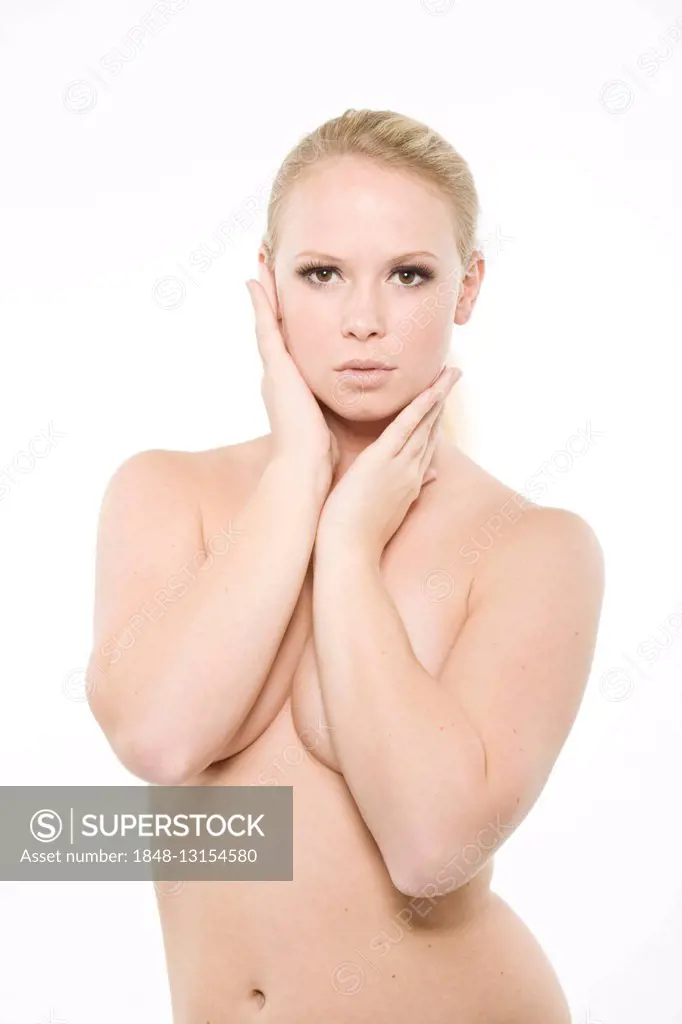 Young, long-haired blonde woman, bare upper body, in front of white backdrop