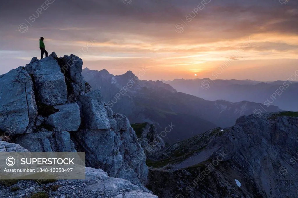 Hiker on top of the Dreitorspitze at sunset, Wetterstein mountains, Garmisch-Partenkirchen, Bavaria, Upper Bavaria, Germany
