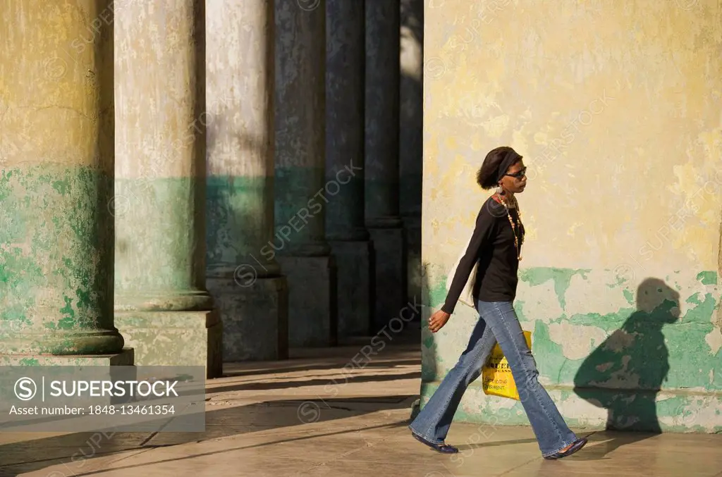 Local woman walking past, Old Havana, Havana, Cuba