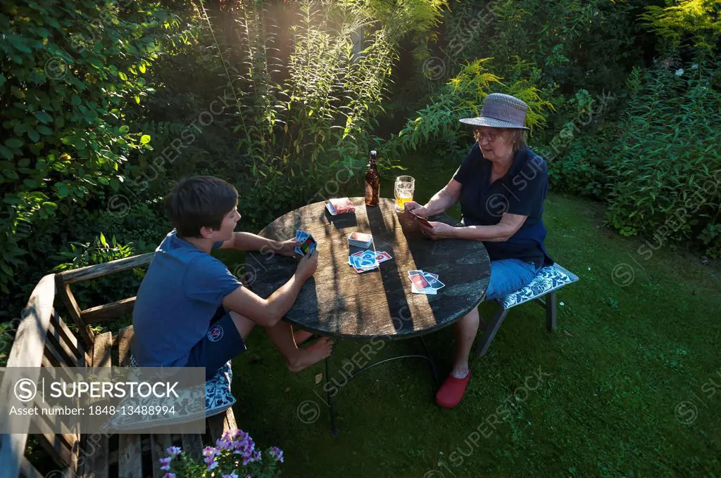 Grandmother playing cards with grandchild, Bavaria, Germany