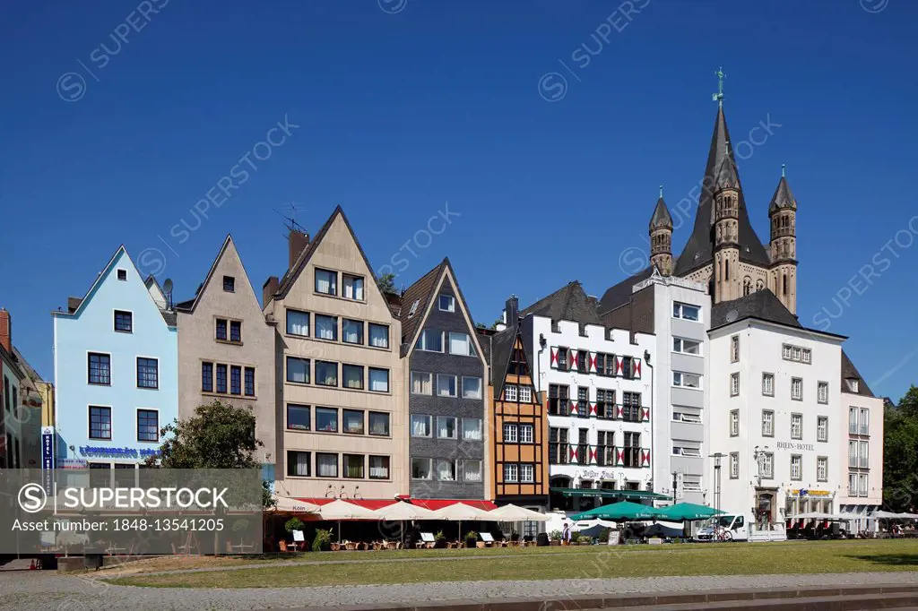 Houses along Rhine river bank, Great St. Martin Church behind, Cologne, North Rhine-Westphalia, Germany
