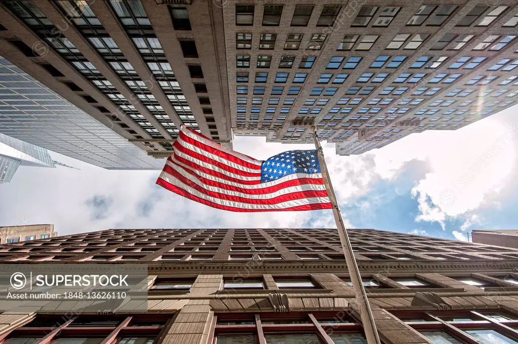 Stars and Stripes, American flag between skyscrapers, low-angle view, Manhattan, New York City, USA