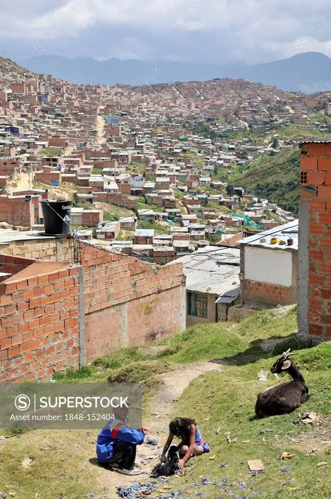 Children playing on a green area, slums of Alto de Cazuca, Soacha, Bogotá, Columbia