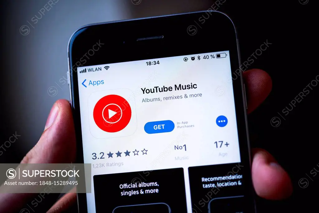 Hand holding iPhone with YouTube Music App in the Apple App Store, music streaming service, video platform, app icon, iPhone, iOS, smartphone, display...