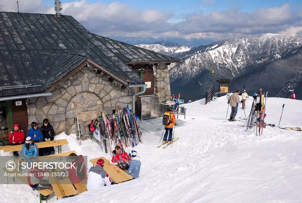Skiers enjoying après ski outside a mountain restaurant at the Lukova Ski Resort, Jasna, Lower Tatras, Slovakia