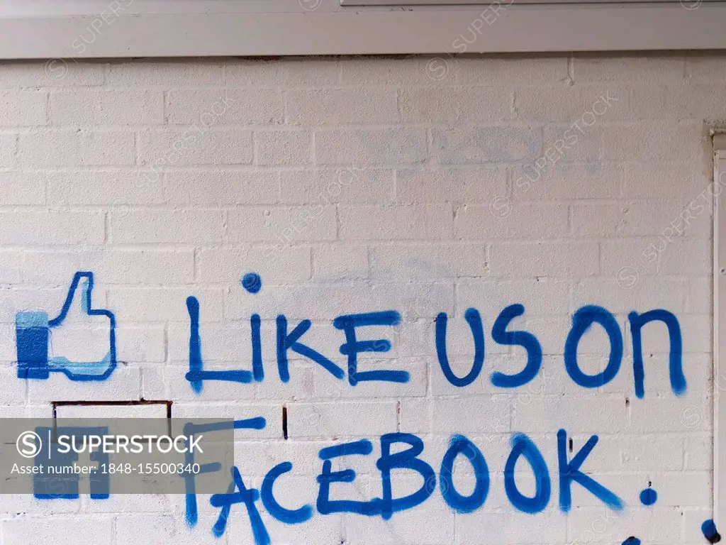 Like us on facebook call to action painted on a brick wall, United Kingdom