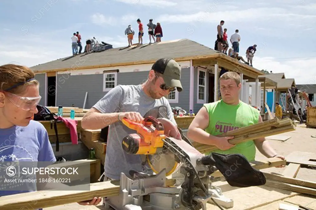 Young volunteers build new houses in a Habitat for a Humanity project to replace some of the housing destroyed by Hurricane Katrina, New Orleans, Louisiana, USA