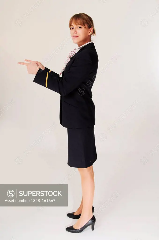 Stewardess, flight attendant gesturing safety instructions