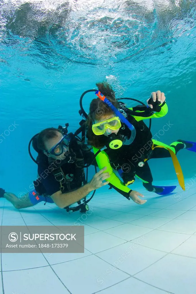 Girl taking scuba lessons in a swimming pool, Indonesia, Asia