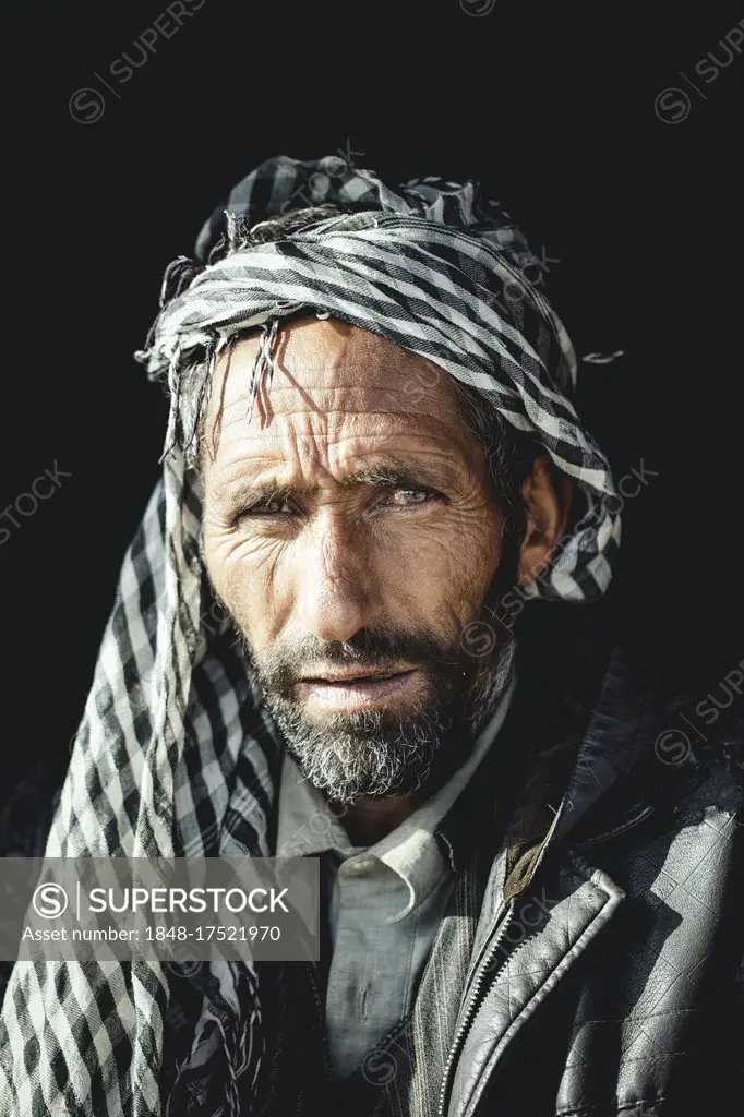 Said, porter and caravan leader with black leather jacket and black and white patterned Kufiya Wakhan corridor, Saradh-e-Broghil, Afghanistan, Asia