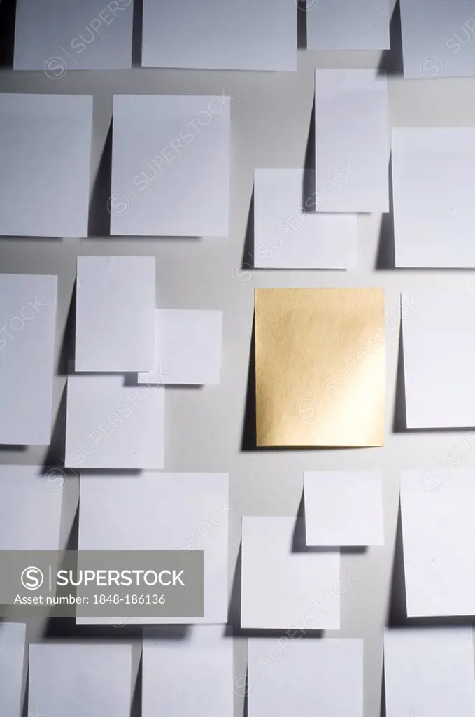 Golden slip of paper among white ones