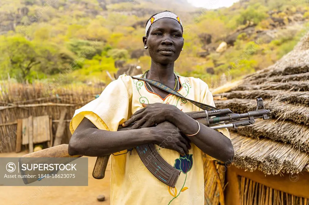 Woman carrying a Kalashnikov, Laarim tribe, Boya hills, Eastern Equatoria, South Sudan, Africa