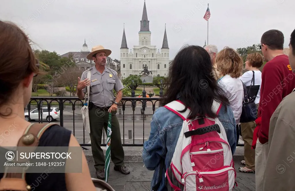 A ranger from Jean Lafitte National Historic Park and Preserve talks to tourists about the history of New Orleans while standing in front of Jackson S...