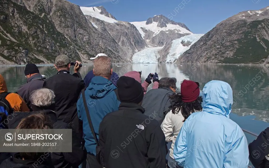 Tourists view Northwestern Glacier from a sightseeing boat in Kenai Fjords National Park, Seward, Alaska, USA