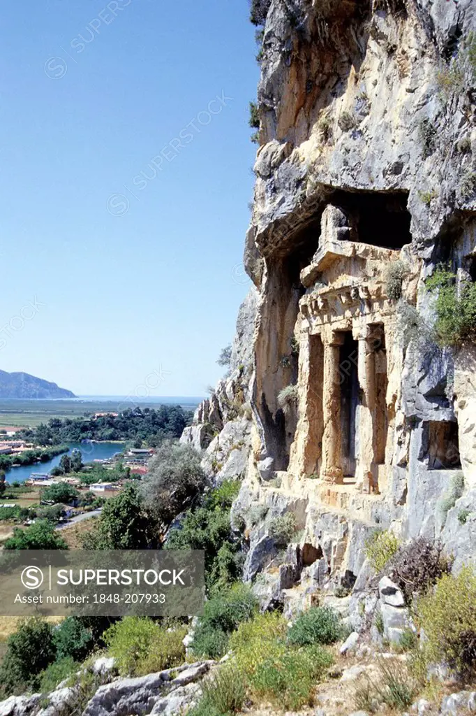 Ancient grave, Lycian rock-cut tomb in a cliff face by a river, river delta near Kaunos, Dalyan in the Mugla Province, Turkey