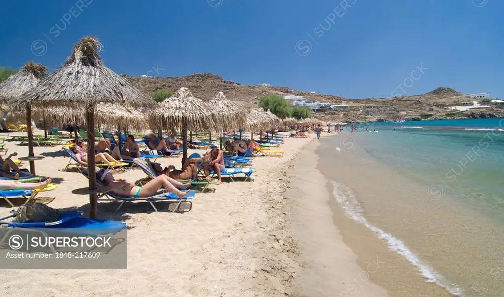 Super Paradise Beach, tourists relaxing on deck chairs underneath sunshades, Mykonos, Cyclades, Greece, Europe