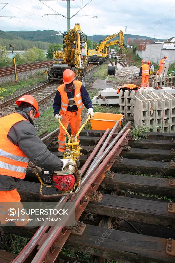 Workers modernise the road bed of the railway