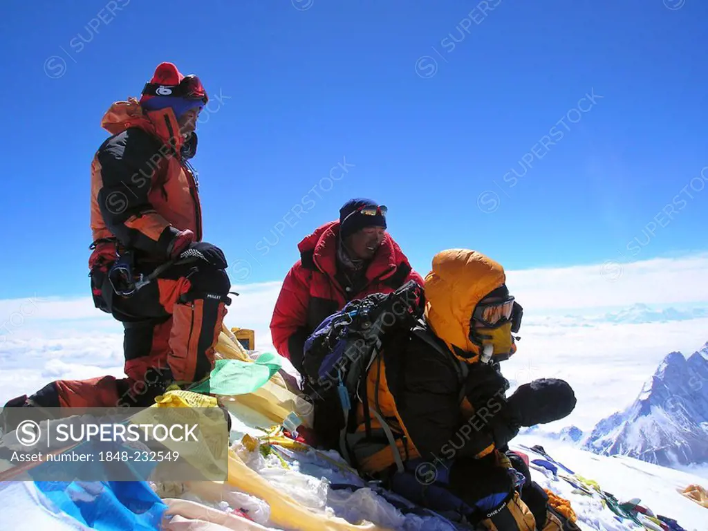 Mingma Sherpa, Fura Kancha Sherpa and austrian Geri Winkler from Vienna with tibetan praying flags on the summit of Mount Everest 8848m, Himalaya, Nep...