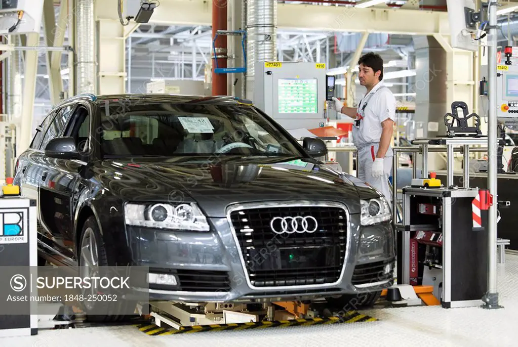 An Audi employee working on the suspension set-up of an Audi A6 Avant S-Line at the control centre of the Audi plant in Neckarsulm, Baden-Wuerttemberg...
