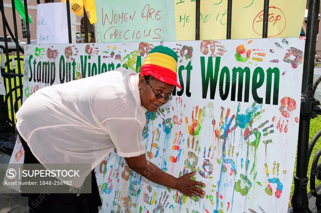 Multi-coloured handprints as a symbol of cooperation between people of various ethnic backgrounds during a protest against violence against women in G...