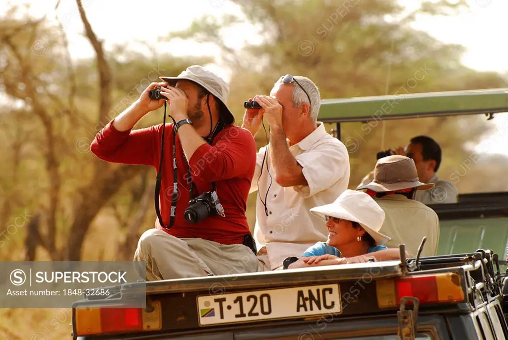 Tourists observing wildlife in Serengeti National Park, Tanzania, Africa