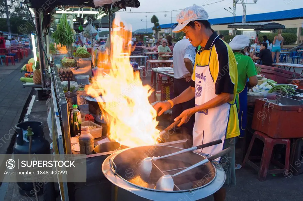 Man cooking at a food stall at the night market, cookshop, Krabi Town, Thailand, Asia