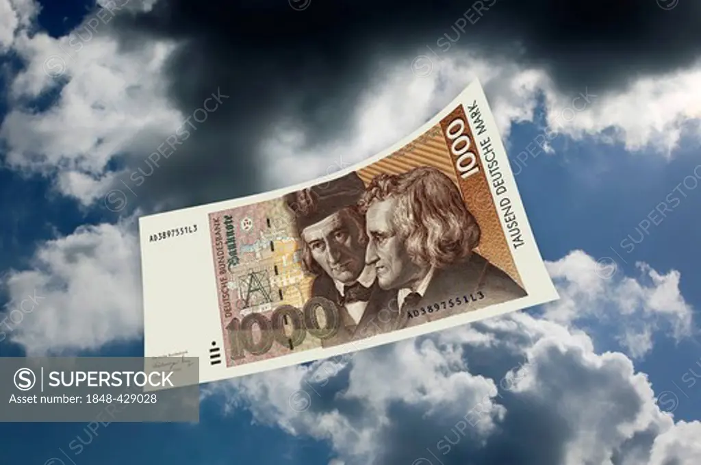 A 1000 DM banknote, Deutsche Mark, German mark, floating in mid-air in front of dark clouds, photomontage