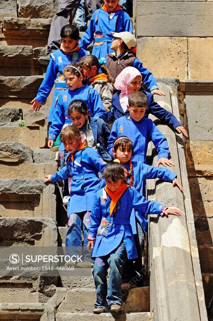Children of a school classin school uniform, Roman theater in Bosra, Syria, Asia