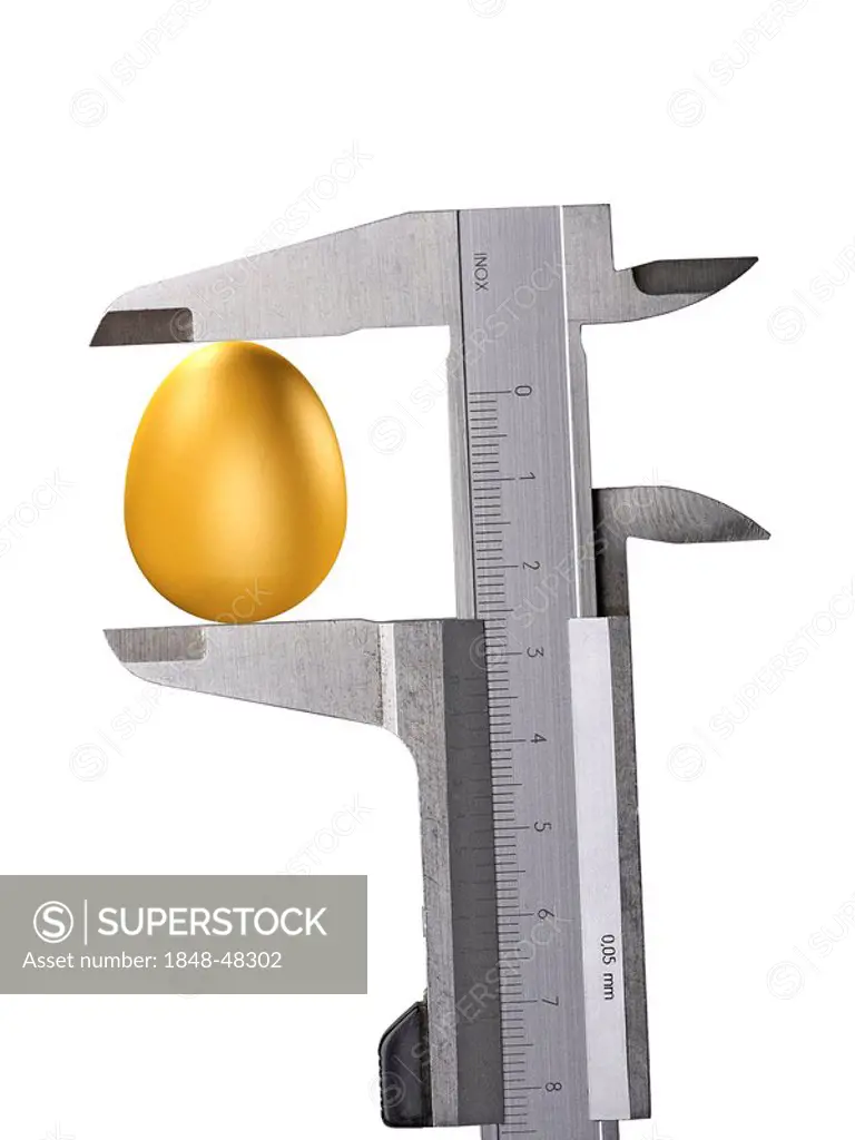 Golden egg (symbolic) held between a calliper, cutout