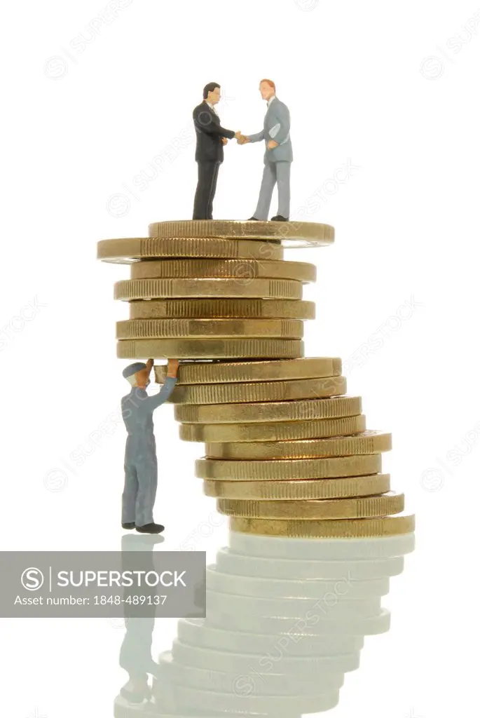 Worker figure propping up a wobbly stack of Euros with two business man figures on top, symbolic image, Euro crisis at the expense of the workers