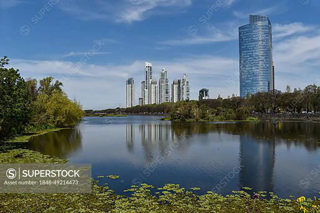 Skyline of Puerto Madero with Alvear Tower, the tallest building in Argentina, reflected in the lake from Costanera Sur Nature Reserve, Buenos Aires, Argentina, South America