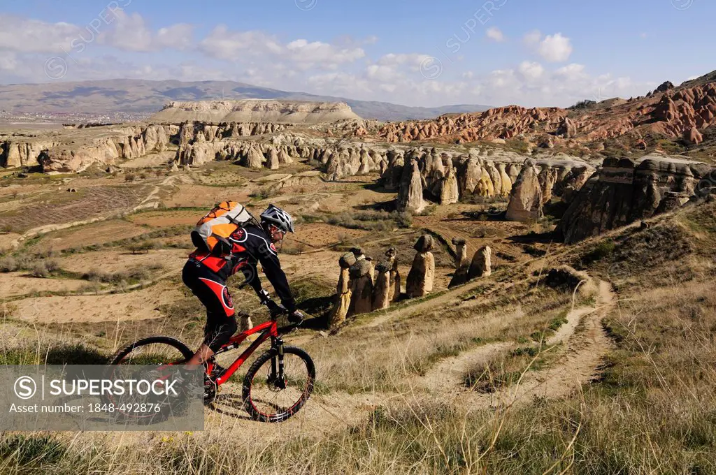 Mountain biker at Cavusim, Goreme Valley, Cappadocia, Turkey, Western Asia