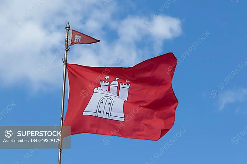 Red flag with the coat of arms of Hamburg against a blue sky in Hamburg, Germany, Europe