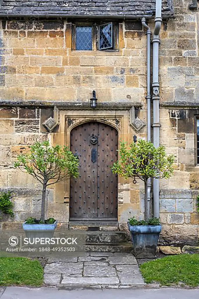 Old stone house in detail with old wooden front door, Broadway, Cotswolds, Worcestershire, England, United Kingdom, Europe