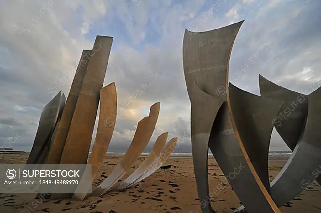 The WW2 American D-Day landing Omaha Beach monument Les Braves on the beach at Saint-Laurent-sur-Mer at sunset, Normandy, France, Europe