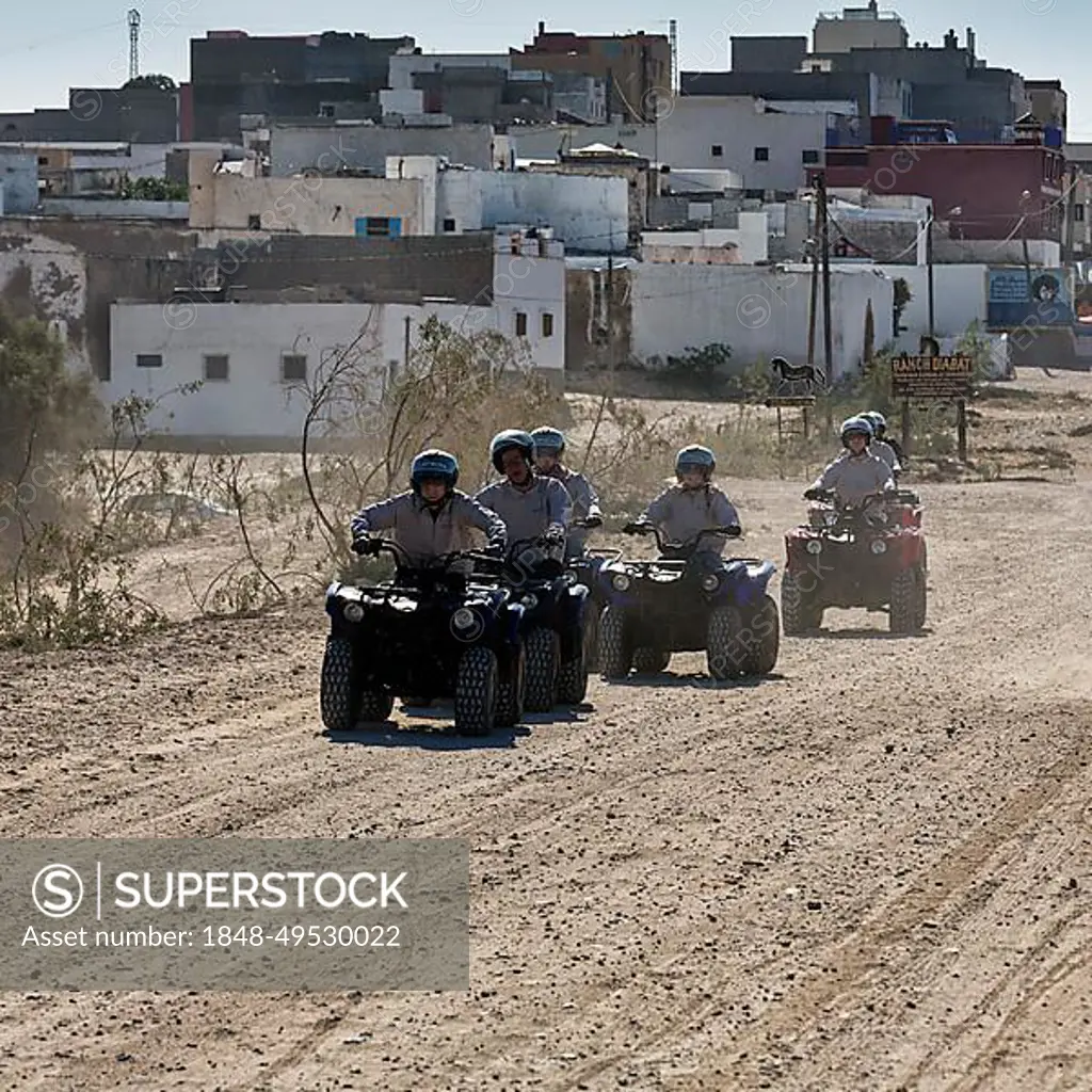 Young quad riders, tourist group on gravel road, Diabat, Essaouira, Morocco, Africa