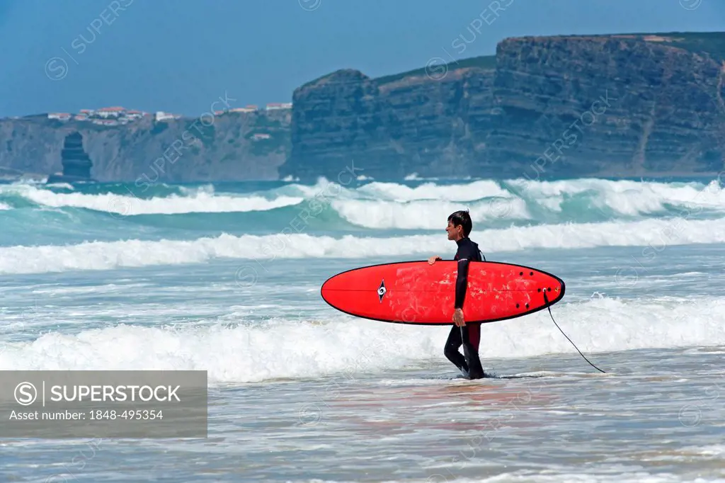 Surfer on the beach of Praia de Vale de Figueira, Costa Dourada, Atlantic Coast, Portugal, Europe