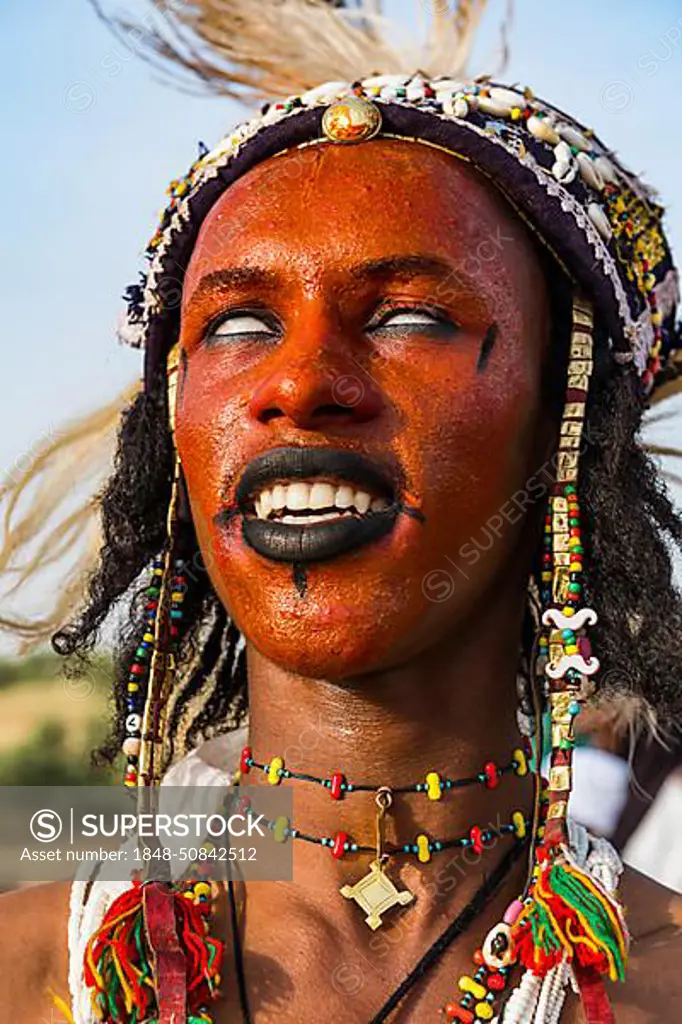 Wodaabe-Bororo man with face painted at the annual Gerewol festival, courtship ritual competition among the Fulani ethnic group, Niger, Africa
