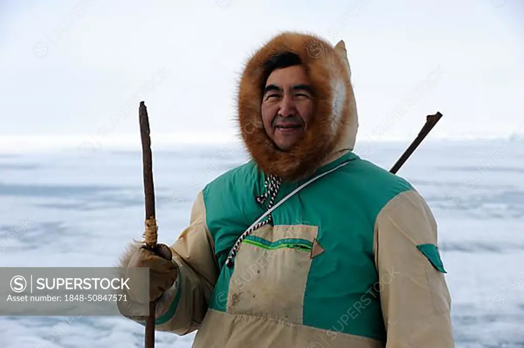 Portrait of Inuit hunter on icepack, Floe Edge, Arctic bay, Baffin Island, Nunavut, Canada, North America