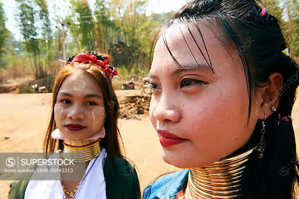 Portrait of 2 young Kayan Lahwi women wearing occasional false neck rings, Pan Pet Region, Kayah State, Myanmar, Asia