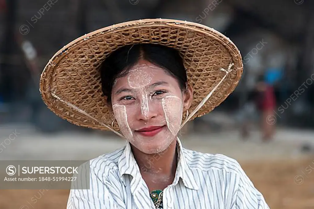 Local woman wearing a straw hat and Thanaka paste on her face, smiling, portrait, Ngapali, Thandwe, Rakhine State, Myanmar, Asia