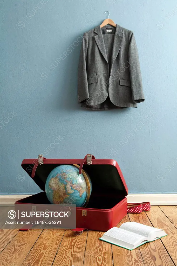 Globe in a suitcase, jacket hanging on a clothes hanger, book, business trip, symbolic image for traveling, world trip