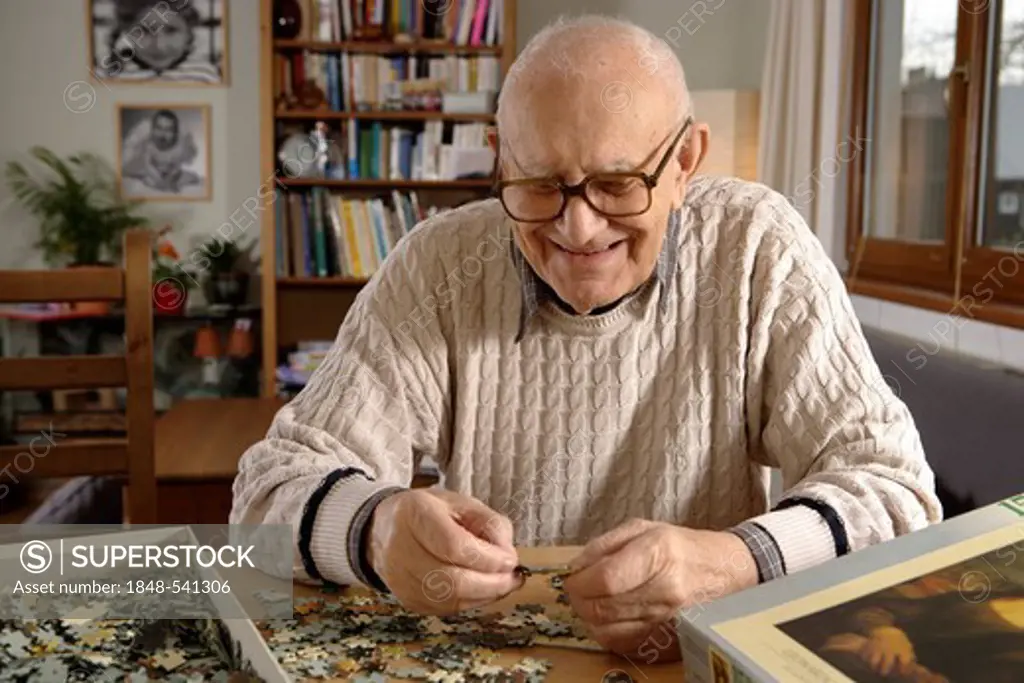 Elderly man, senior, 92, doing a puzzle