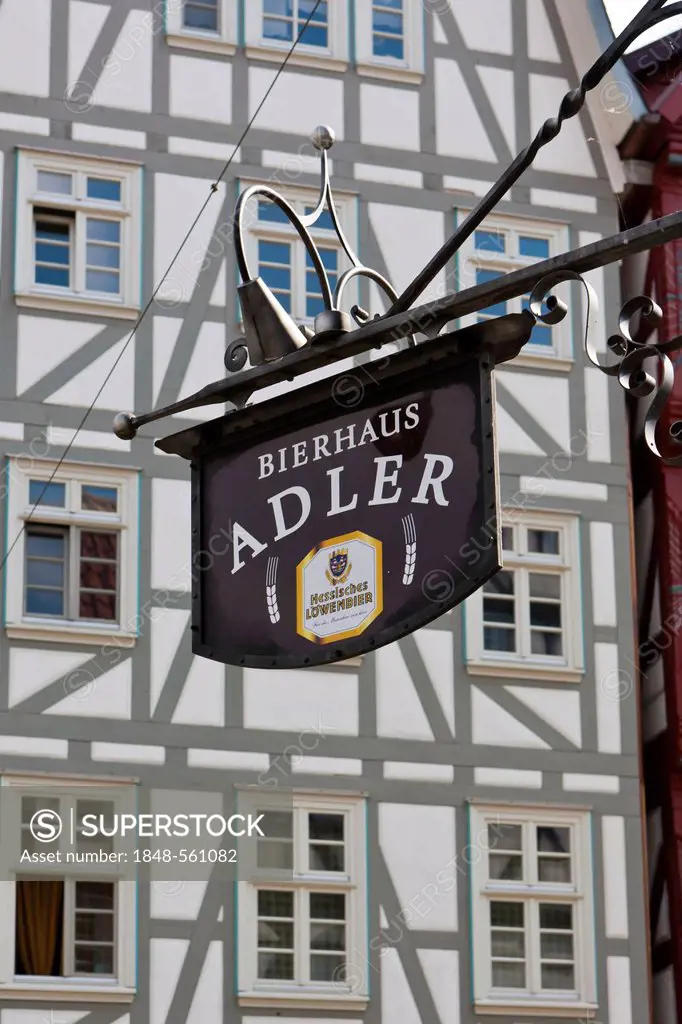 Hanging sign, Bierhaus Adler in front a half-timbered house, market place, Melsungen, Hesse, Germany, Europe, PublicGround