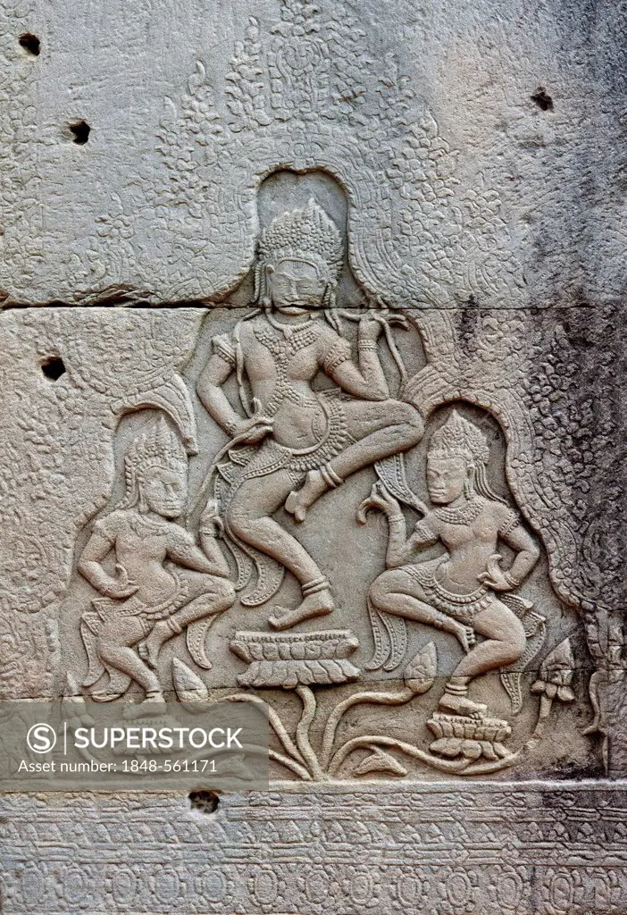 Stone bas-relief of a group of three apsaras dancing on lotuses, Bayon Temple, Angkor Thom, Siem Reap, Cambodia, Southeast Asia, Asia