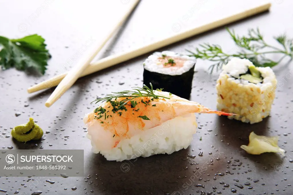 Assorted sushi with ginger and wasabi on a stone surface