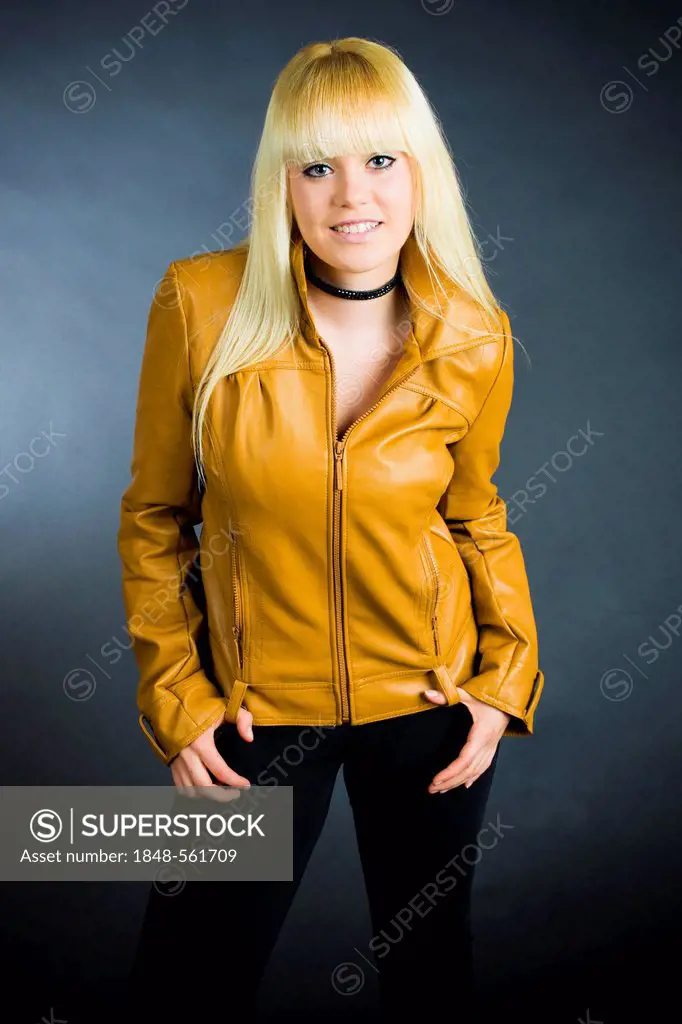 Young blond woman wearing a leather jacket