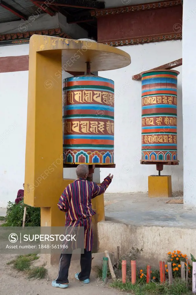 Tibetan Buddhism, believer spinning a large modern prayer wheel, Thimphu, the Himalayas, Kingdom of Bhutan, South Asia, Asia