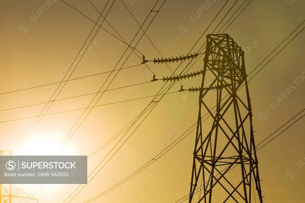 High voltage electricity pylon in the evening sun, American Canyon, California, USA