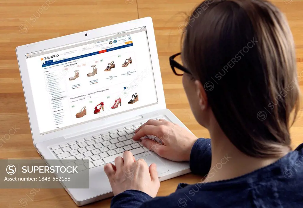 Woman surfing the internet with a laptop, Zalando, online shoe store